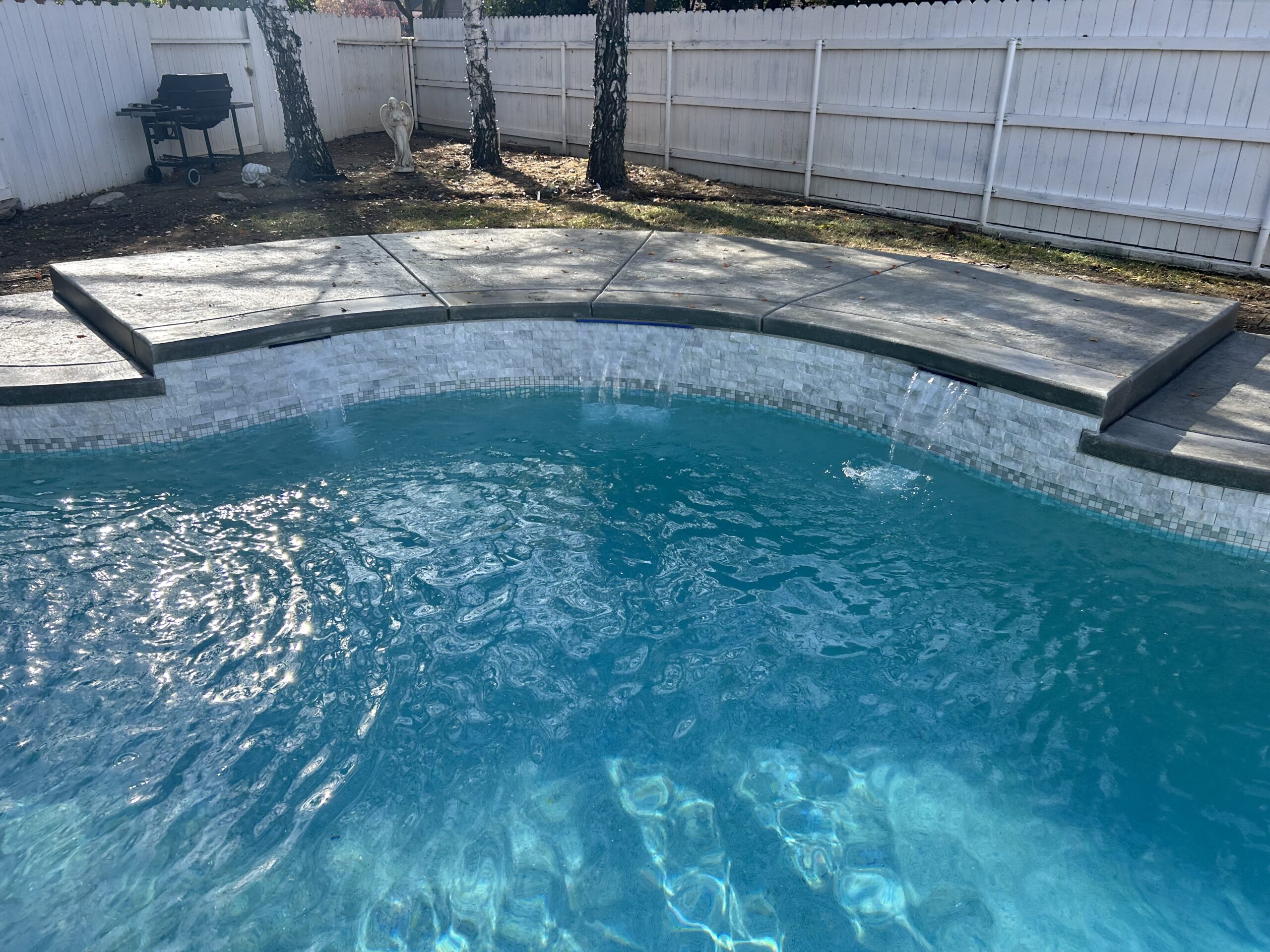 Completed backyard pool remodel with new plaster finish