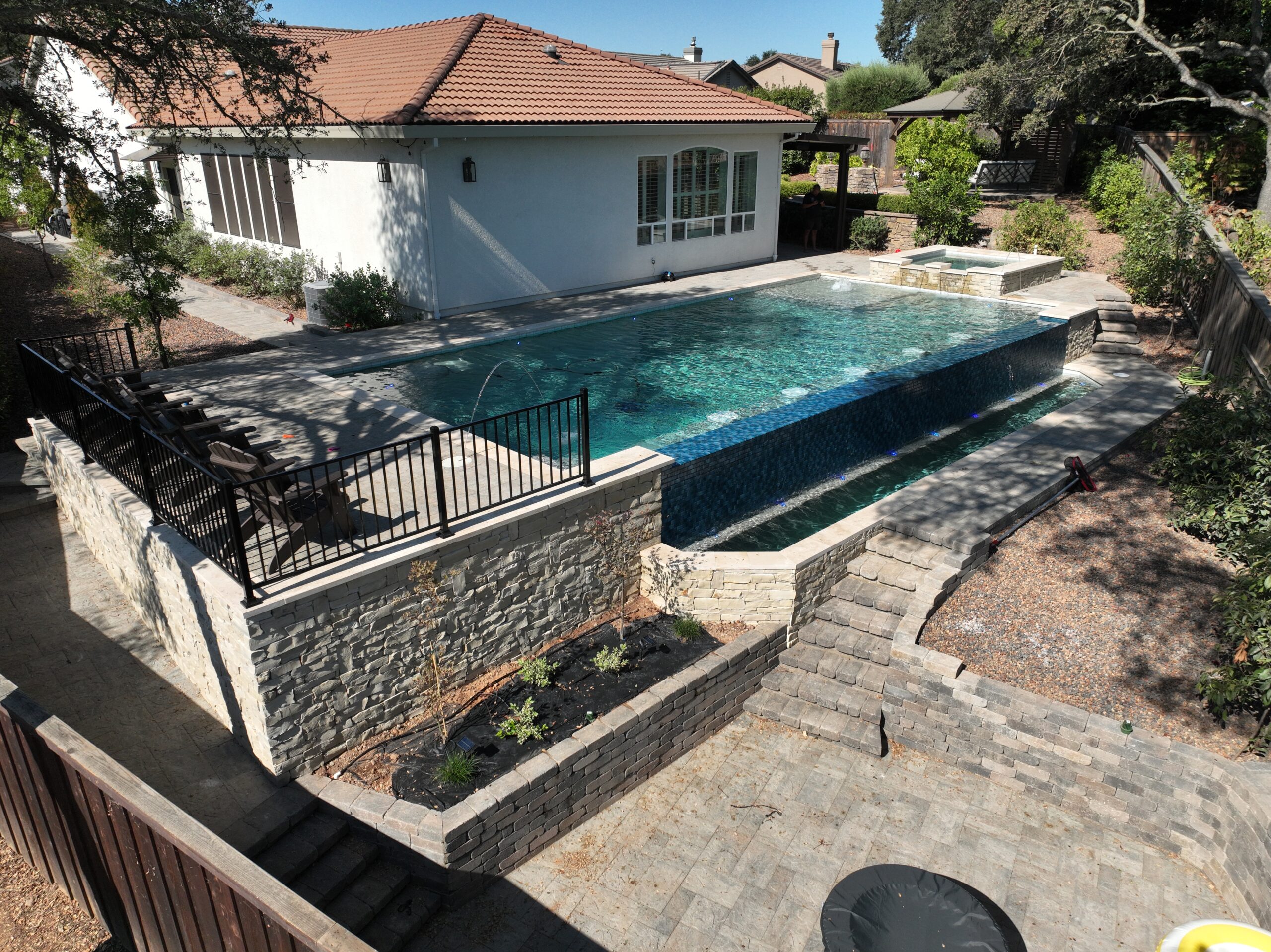 Aerial view of a custom backyard swimming pool project by Sacramento Pool Pros for a Sacramento-area home