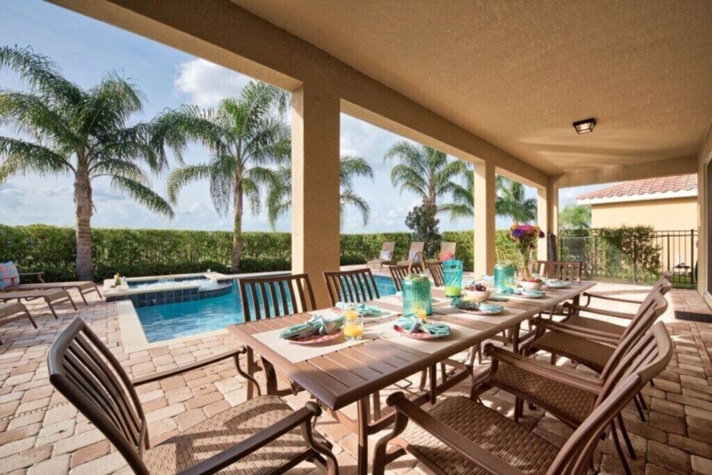 Outdoor dining area near a backyard swimming pool