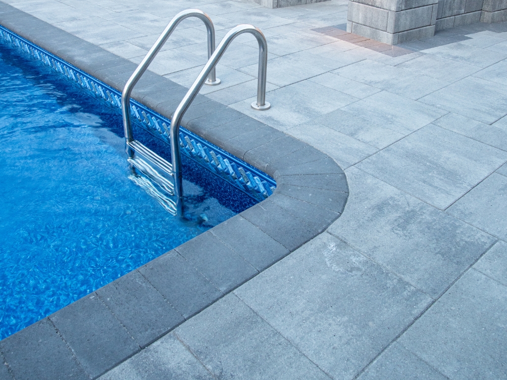 Pool deck coping and tile detail during inspection