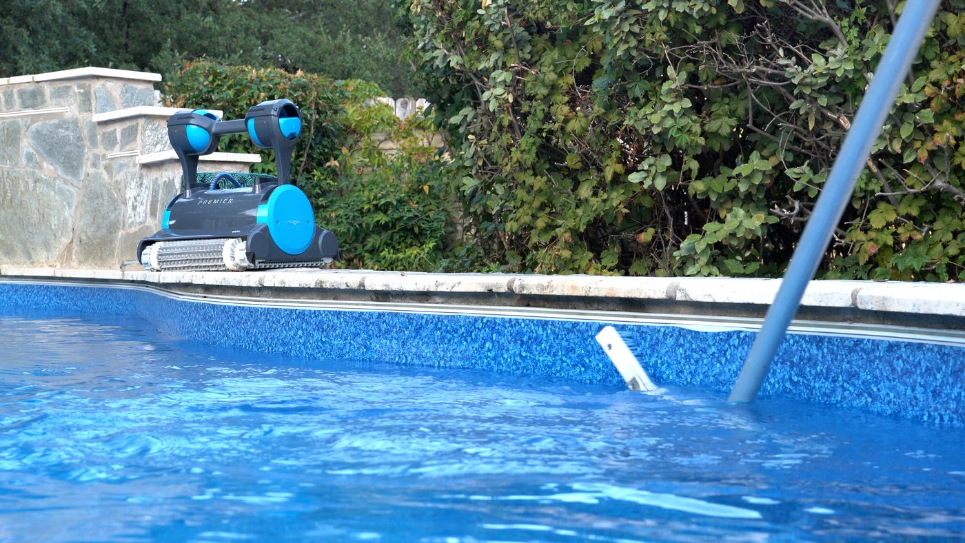 Clean swimming pool being brushed during pool maintenance